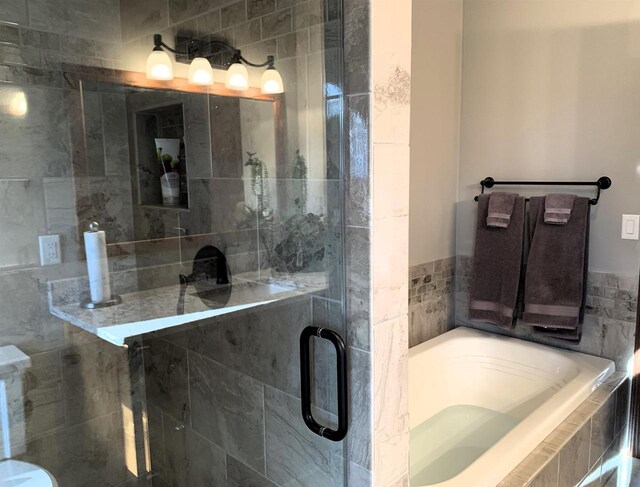 bathroom with separate shower and tub