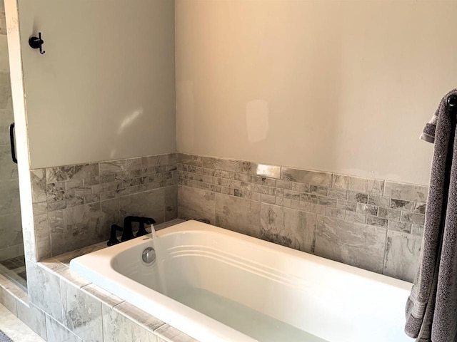 bathroom featuring tiled bath