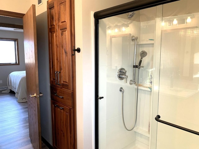 bathroom with wood-type flooring and walk in shower
