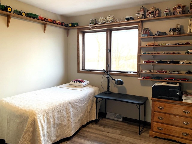 bedroom with hardwood / wood-style floors