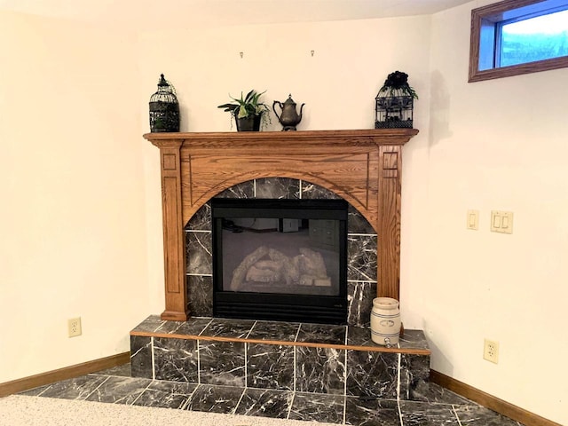interior details featuring a tiled fireplace