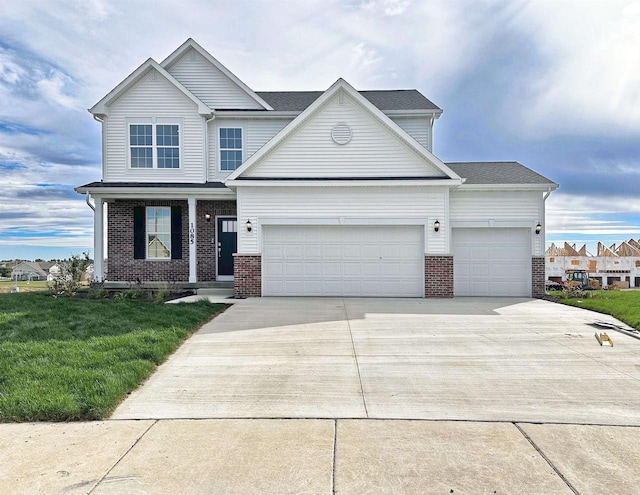 view of front facade with a garage, driveway, brick siding, and a front yard