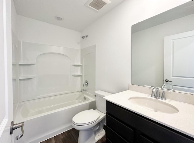 full bath with shower / bath combination, visible vents, toilet, vanity, and wood finished floors