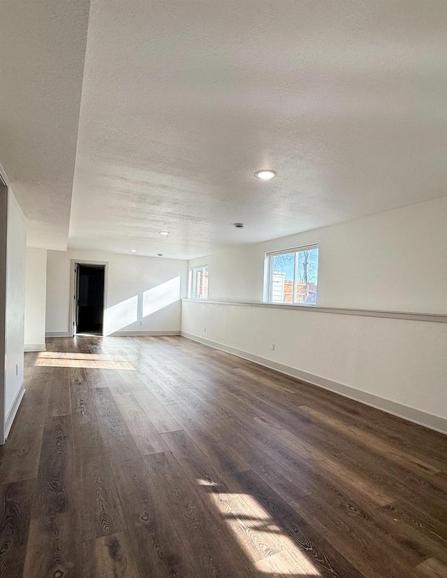 empty room featuring dark hardwood / wood-style floors and a textured ceiling