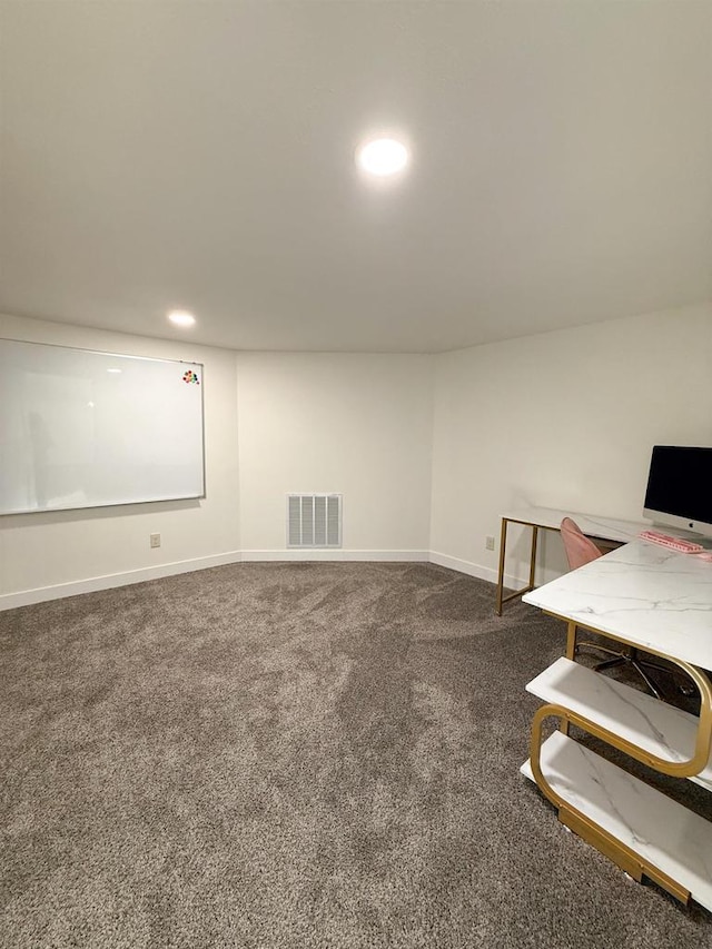 basement with dark colored carpet