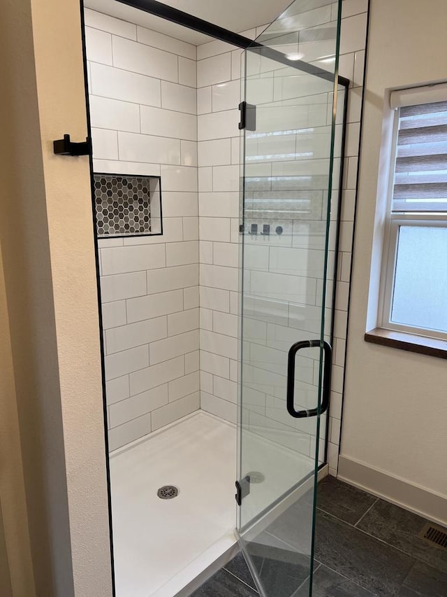 bathroom featuring tile patterned floors and a shower with shower door