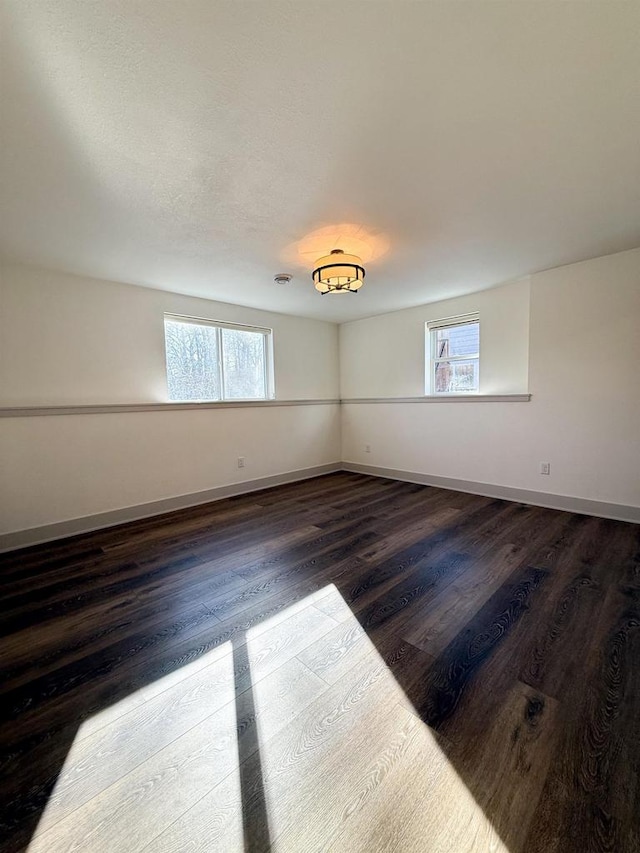 spare room with dark hardwood / wood-style flooring