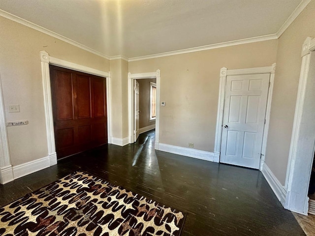 unfurnished bedroom featuring crown molding and dark hardwood / wood-style floors