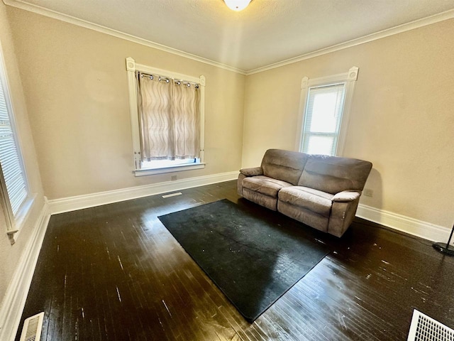 living area featuring dark hardwood / wood-style flooring and crown molding