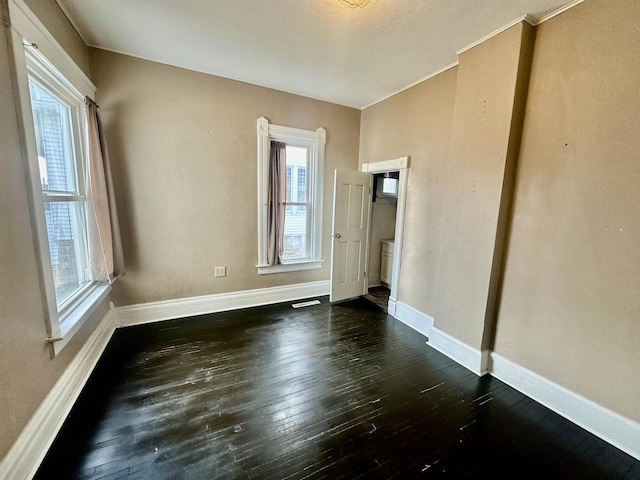 spare room with dark wood-type flooring