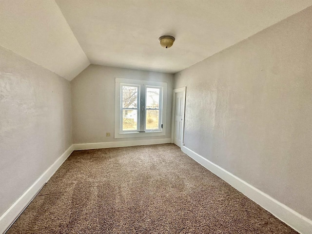 additional living space with carpet floors and vaulted ceiling