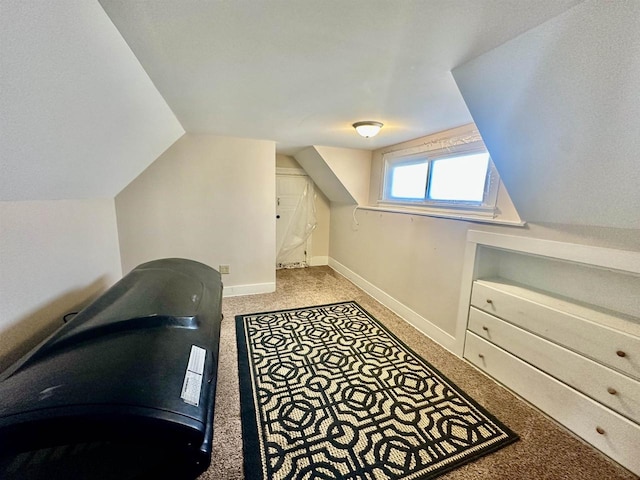 carpeted home office with lofted ceiling