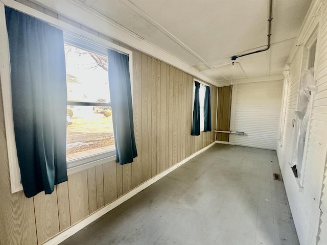 spare room featuring wood walls