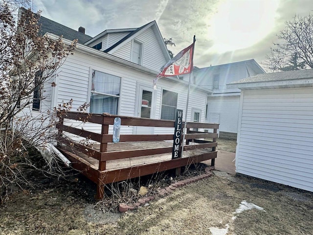 back of house featuring a wooden deck