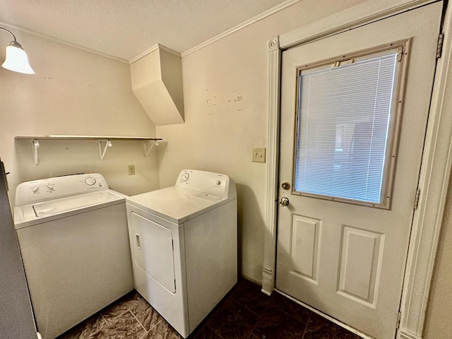 clothes washing area with crown molding, a textured ceiling, and independent washer and dryer