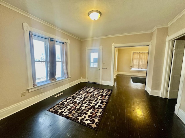 entrance foyer with crown molding and dark wood-type flooring