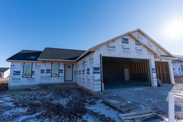 unfinished property featuring a garage