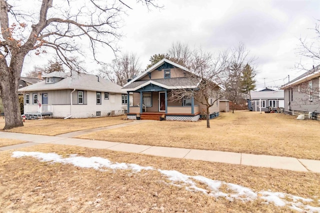 view of front of home with covered porch and a front lawn