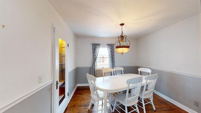 dining space featuring dark hardwood / wood-style flooring