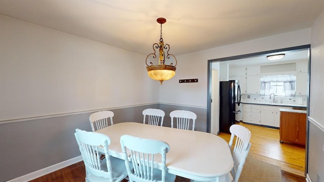 dining area featuring sink and light hardwood / wood-style floors