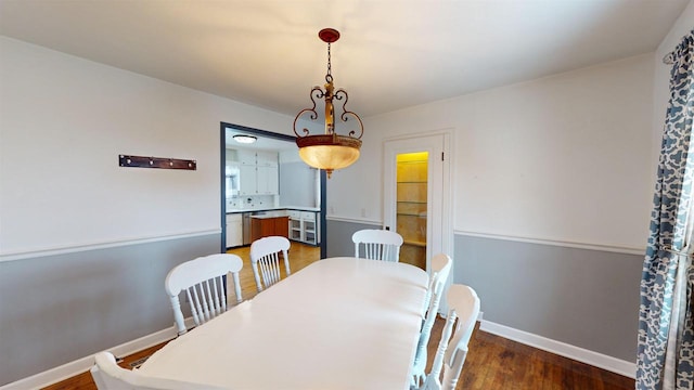 dining room with dark hardwood / wood-style flooring