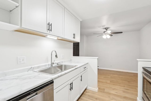 kitchen with sink, dishwasher, ceiling fan, light hardwood / wood-style floors, and white cabinets