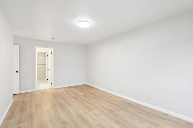 unfurnished room with light wood-type flooring