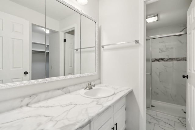 bathroom with vanity and a shower with shower door