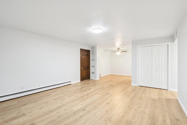 empty room with light hardwood / wood-style flooring, a baseboard radiator, and ceiling fan