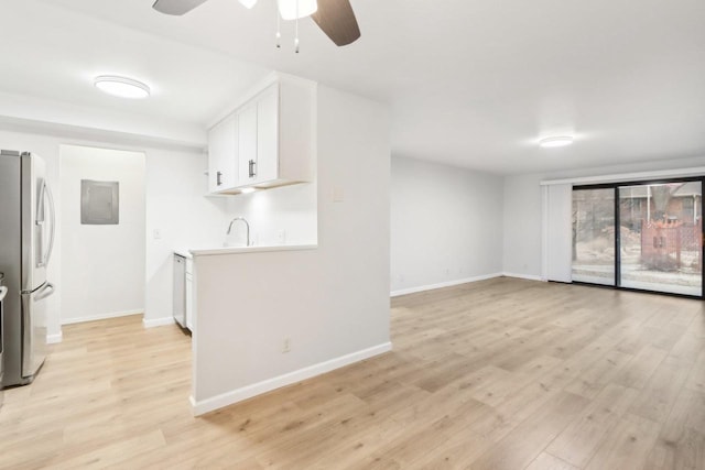 kitchen featuring white cabinetry, stainless steel fridge, electric panel, ceiling fan, and light wood-type flooring