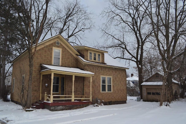 view of front of property with a garage, an outbuilding, and covered porch