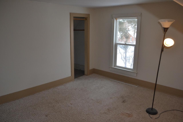 unfurnished bedroom with multiple windows and light carpet