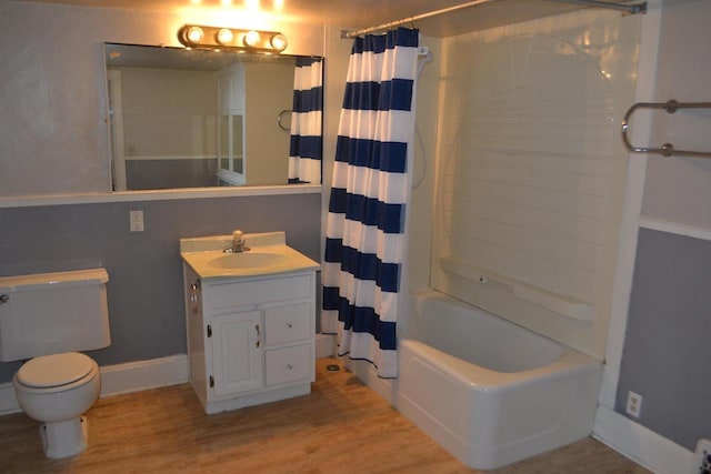 full bathroom featuring toilet, hardwood / wood-style floors, vanity, and shower / bath combo with shower curtain