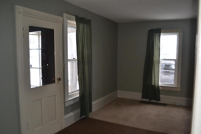 view of carpeted foyer entrance