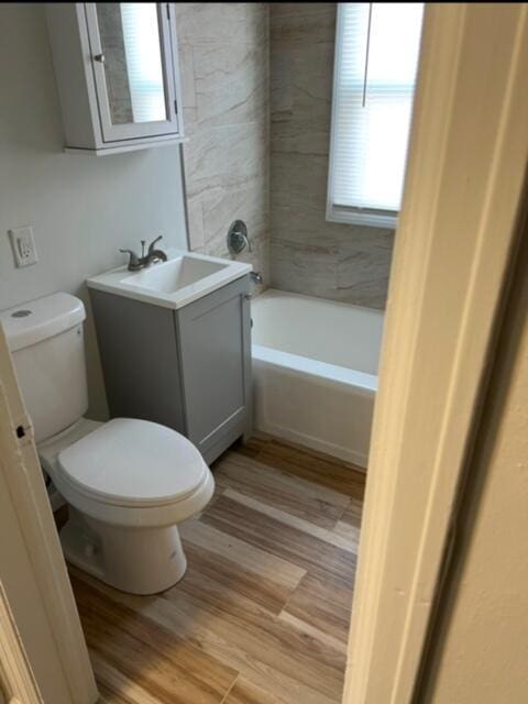 bathroom featuring vanity, hardwood / wood-style floors, and toilet