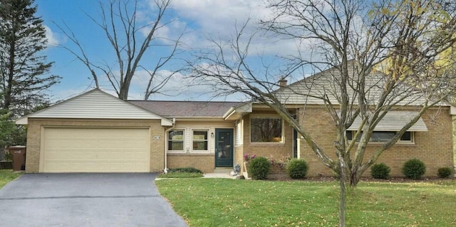 ranch-style home with a garage and a front yard