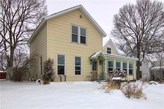 view of snow covered rear of property