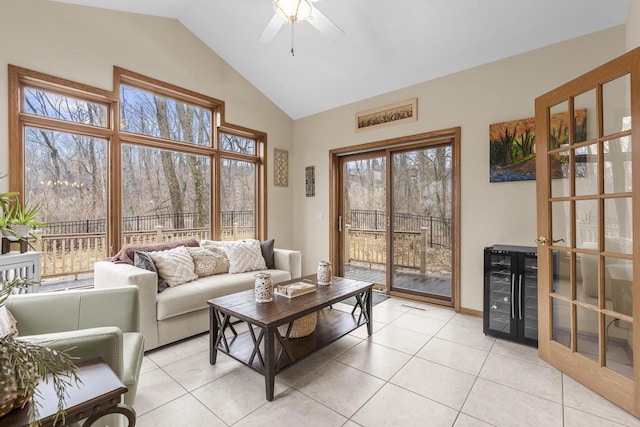 living room featuring light tile patterned flooring, high vaulted ceiling, and ceiling fan