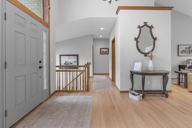 foyer featuring a towering ceiling and light hardwood / wood-style flooring