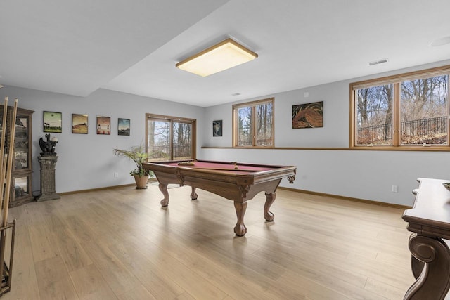 playroom with pool table, a wealth of natural light, and light hardwood / wood-style floors