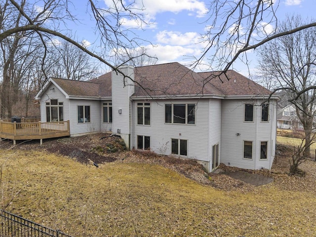 rear view of house with a yard and a deck