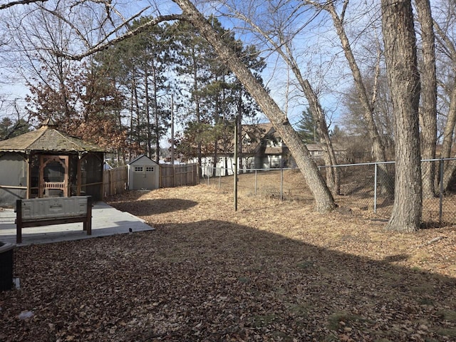 view of yard featuring a gazebo and a storage unit