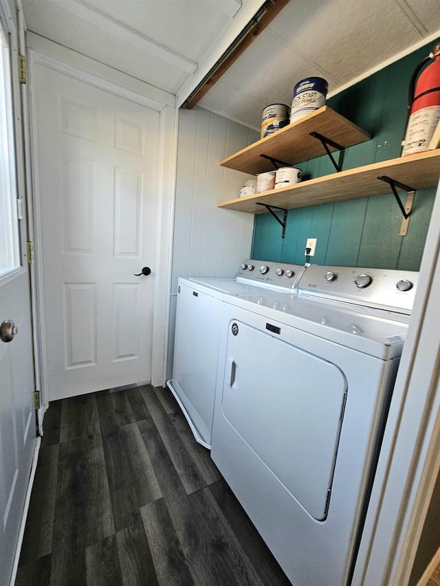 washroom with dark hardwood / wood-style flooring and independent washer and dryer