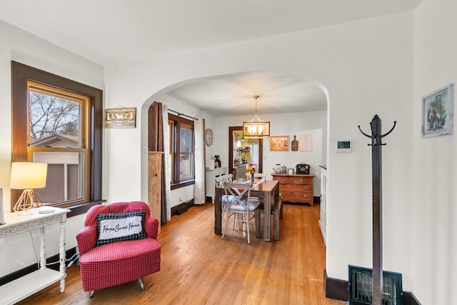 interior space with light hardwood / wood-style floors, a chandelier, and a healthy amount of sunlight