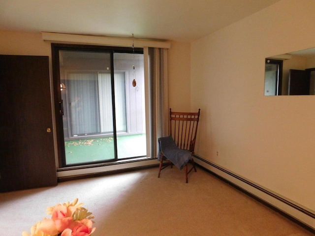 unfurnished room featuring a baseboard radiator and carpet