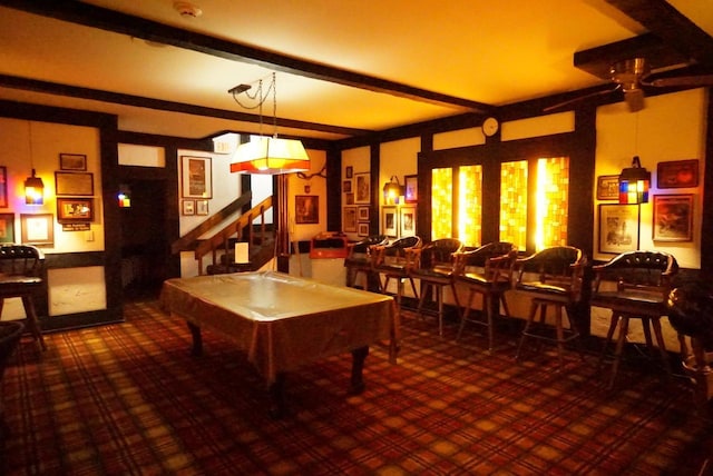 recreation room with beamed ceiling