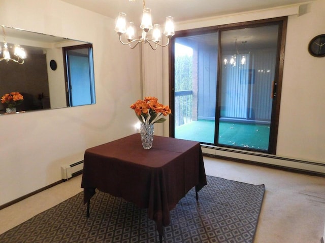 dining space with a baseboard heating unit, carpet floors, and a chandelier