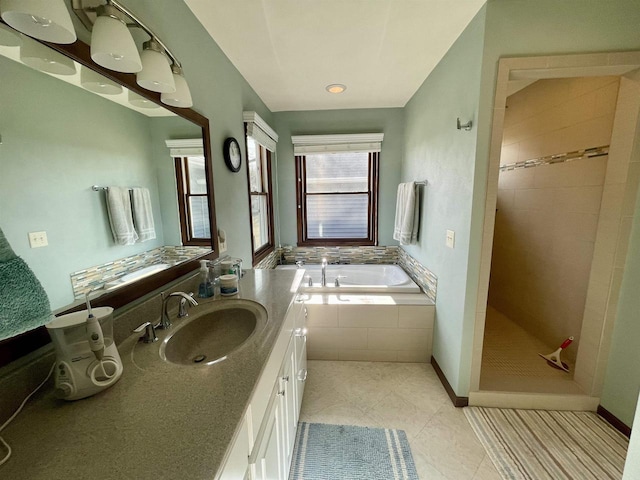 bathroom featuring vanity, plus walk in shower, and tile patterned flooring