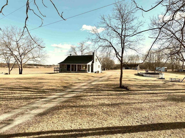 view of yard with a rural view