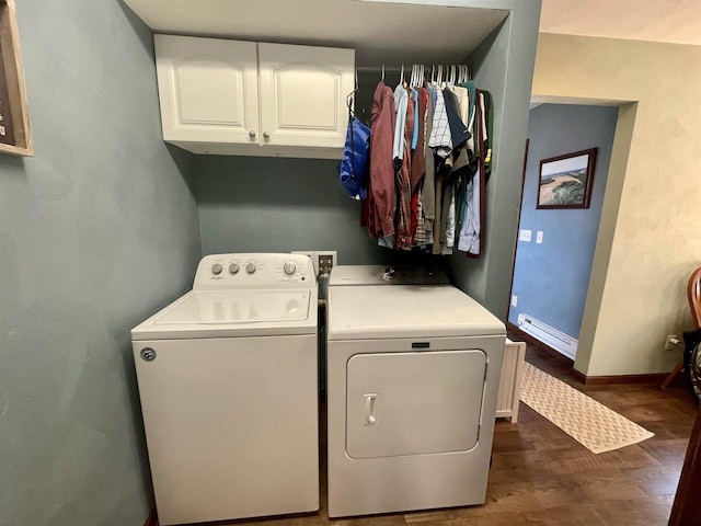 laundry room with baseboard heating, cabinets, dark hardwood / wood-style flooring, and washer and clothes dryer